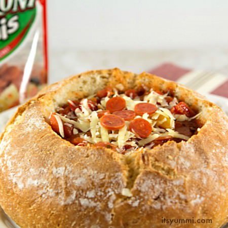 This slow cooker pizza soup recipe has all of the taste of a sausage and pepperoni pizza, served up in a delicious crusty bread bowl! It's SO yummi! #PepItUp #ad