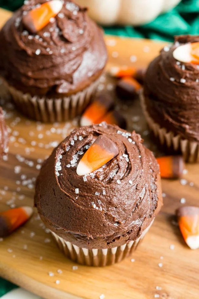 Chocolate Pumpkin Cupcakes on walnut cutting board