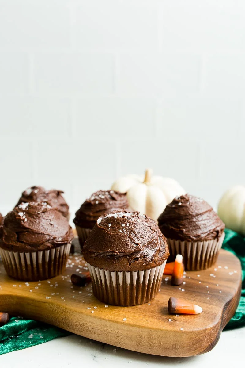 Chocolate Pumpkin Cupcakes on walnut cutting board