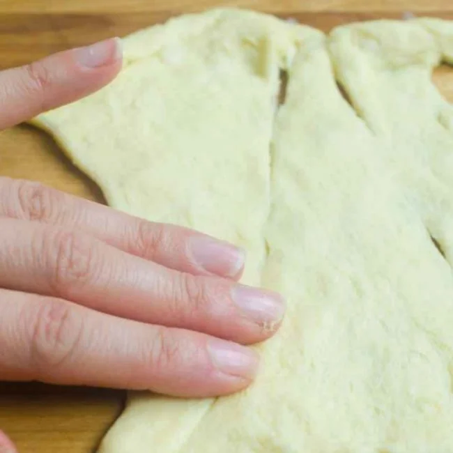pressing seams of crescent roll dough together