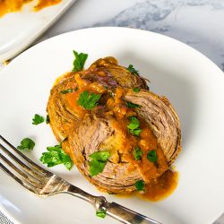 stuffed flank steak dinner on a plate