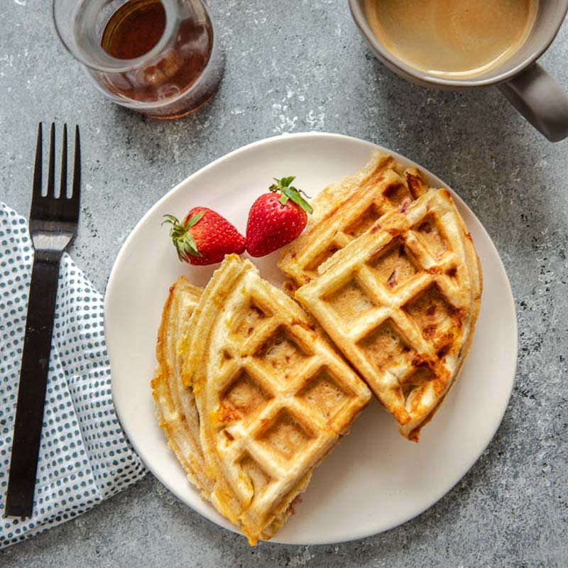 overhead shot of ham and cheddar stuffed waffles