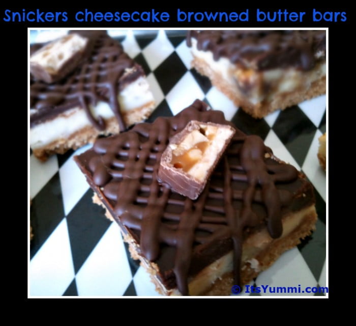 Snicker's Cheesecake Bars - This decadent dessert recipe has a brown butter crust, a layer of Snicker's cheesecake, and lots of chocolate ganache on top. SO flippin' good!