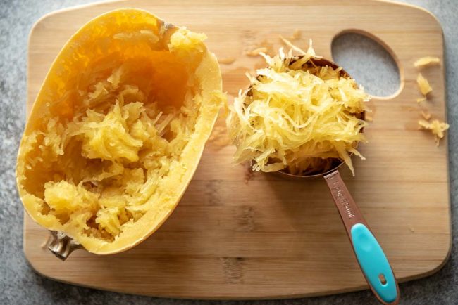 removing strands of spaghetti squash from the cooked squash