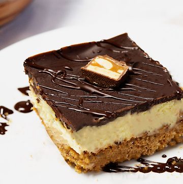 Snickers cheesecake bars with a brown butter crust