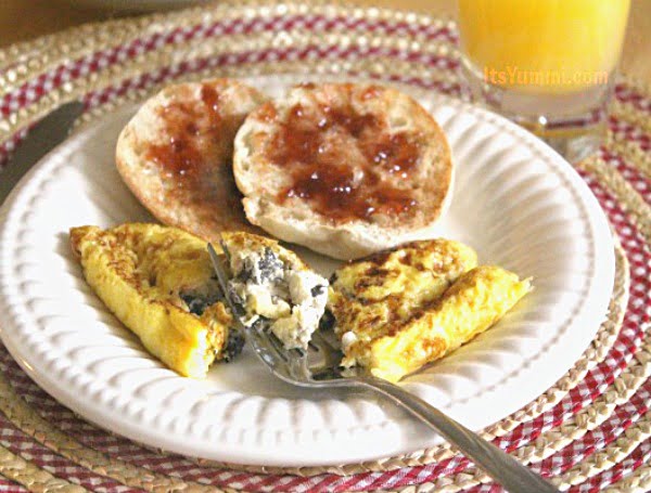 Cheesy Crab Omelet Recipe - Perfect for breakfast or brunch, this easy-to-make omelet is loaded with veggies, 2 types of cheese, and flaky crab meat. SO good! - Recipe on itsyummi.com