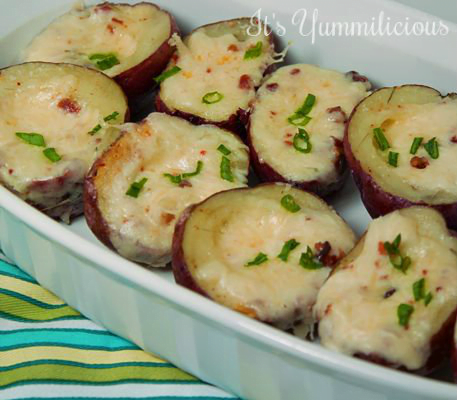 Twice Baked Potato Bites from ItsYummi.com - Baby red baked potatoes that are filled with a potato, bacon, and cheese mixture, then baked up again until theiy're warm, cheesy, and delicious. Perfect as an appetizer or game day snack.