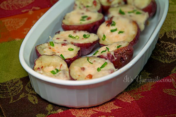 Twice Baked Potato Bites from ItsYummi.com - Baby red baked potatoes that are filled with a potato, bacon, and cheese mixture, then baked up again until theiy're warm, cheesy, and delicious. Perfect as an appetizer or game day snack.