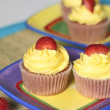 2 strawberry lemonade cupcakes on a dessert plate