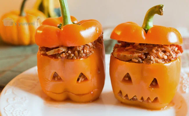 Halloween Stuffed Peppers - one of our favorite Halloween main dishes! Filled with Italian flavors and a roasted red pepper sauce, this recipe makes a delicious and fun family dinner for #Halloween - #recipe #holidays #stuffedpeppers Halloween Stuffed Peppers - one of our favorite Halloween main dishes!