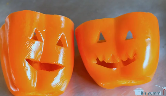 Halloween Stuffed Peppers - one of our favorite Halloween main dishes! Filled with Italian flavors and a roasted red pepper sauce, this recipe makes a delicious and fun family dinner for #Halloween - #recipe #holidays #stuffedpeppers Jack O Lantern Stuffed Bell Peppers recipe - a fun and delicious Halloween dinner! Get the recipe on ItsYummi.com