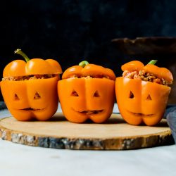 Halloween stuffed peppers carved to look like Jack O Lanterns
