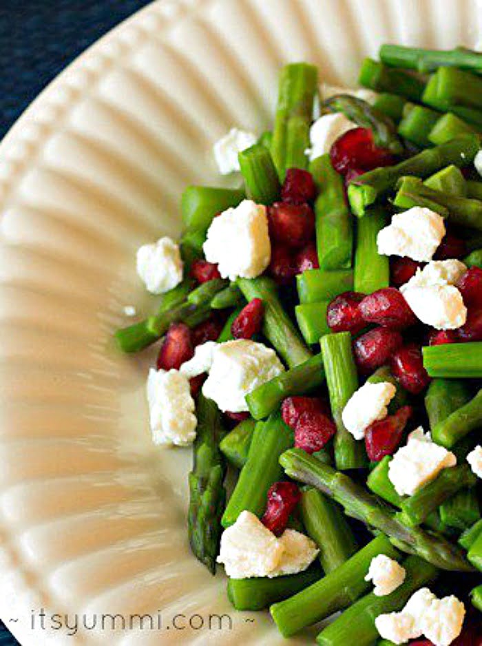 Jeweled asparagus is an amazing side dish! Crisp asparagus and sweet pomegranate arils are paired with cheese made from vanilla Greek yogurt. SO delicious!
