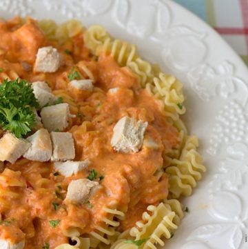 plate of chicken alfredo with roasted red pepper sauce