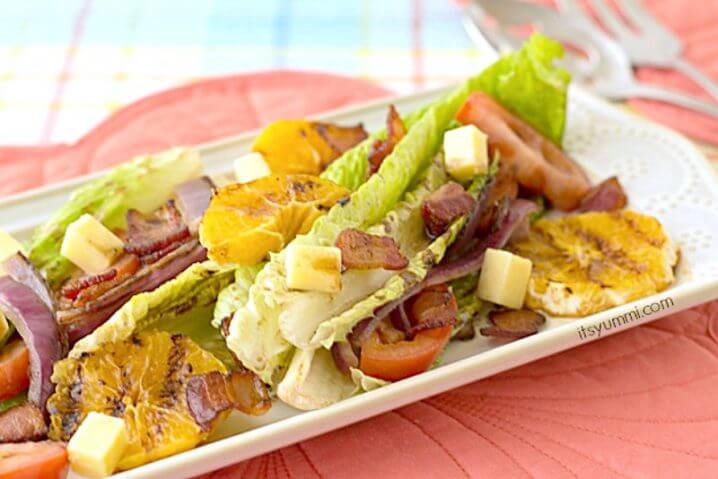 Grilled Romaine Salad with Pomegranate Balsamic Vinaigrette - Grilled romaine is paired with grilled oranges, bacon, blue cheese, and your favorite salad toppings for a delicious, healthy dinner! Get the recipe from @itsyummi