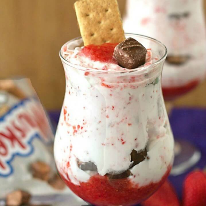 Chocolate Strawberry Candy Bar Parfaits - A fun and easy to make dessert recipe from @itsyummi with layers of strawberry fool, fluffy homemade whipped cream, and bite sized candy bars - Get the recipe on itsyummi.com