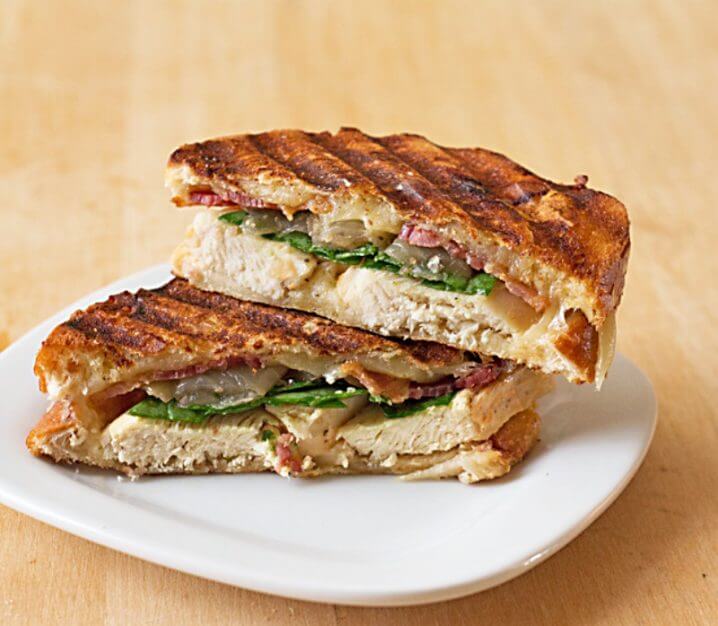 Cheesy Grilled Chicken Panini Sandwich - Crispy bacon, caramelized onions, baby spinach, and lots of cheese, grilled up between layers of 3-cheeses sourdough. Recipe from @itsyummi