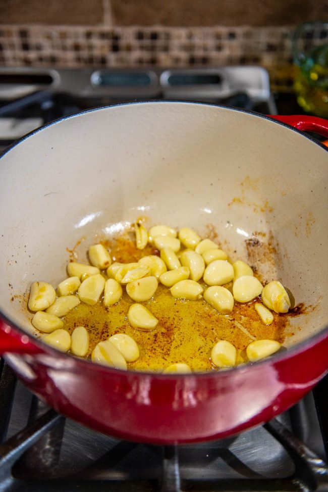 fresh cloves of garlic sauteing in a pan