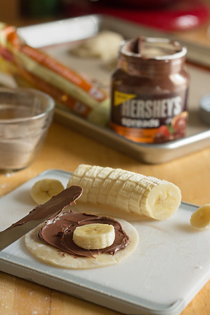 Nutty Banana Chocolate Hand Pies - A sweet treat! Flaky pastry is full of chocolate hazelnut spread, bananas, and chopped nuts. Get the recipe from @itsyummi