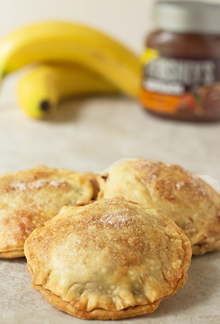 Nutty Banana Chocolate Hand Pies - A sweet treat! Flaky pastry is full of chocolate hazelnut spread, bananas, and chopped nuts. Get the recipe from @itsyummi