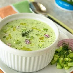 cold cucumber soup garnished with fresh dill and a drizzle of olive oil