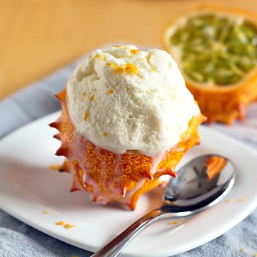 scoop of eggless vanilla orange ice cream served in a Kiwano fruit shell