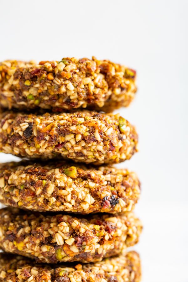 A close up side view of a stack of no bake pistachio oat cookies