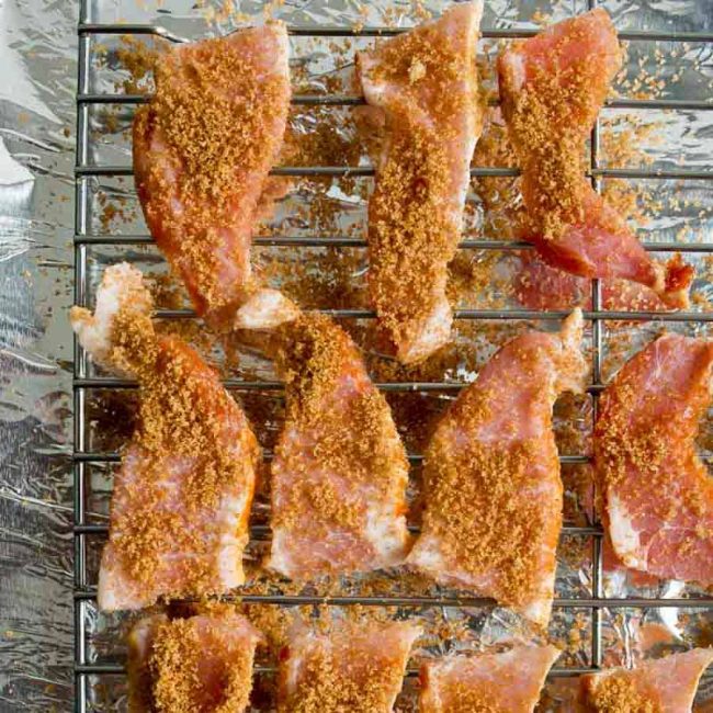 Candied bacon on a tinfoil lined baking sheet