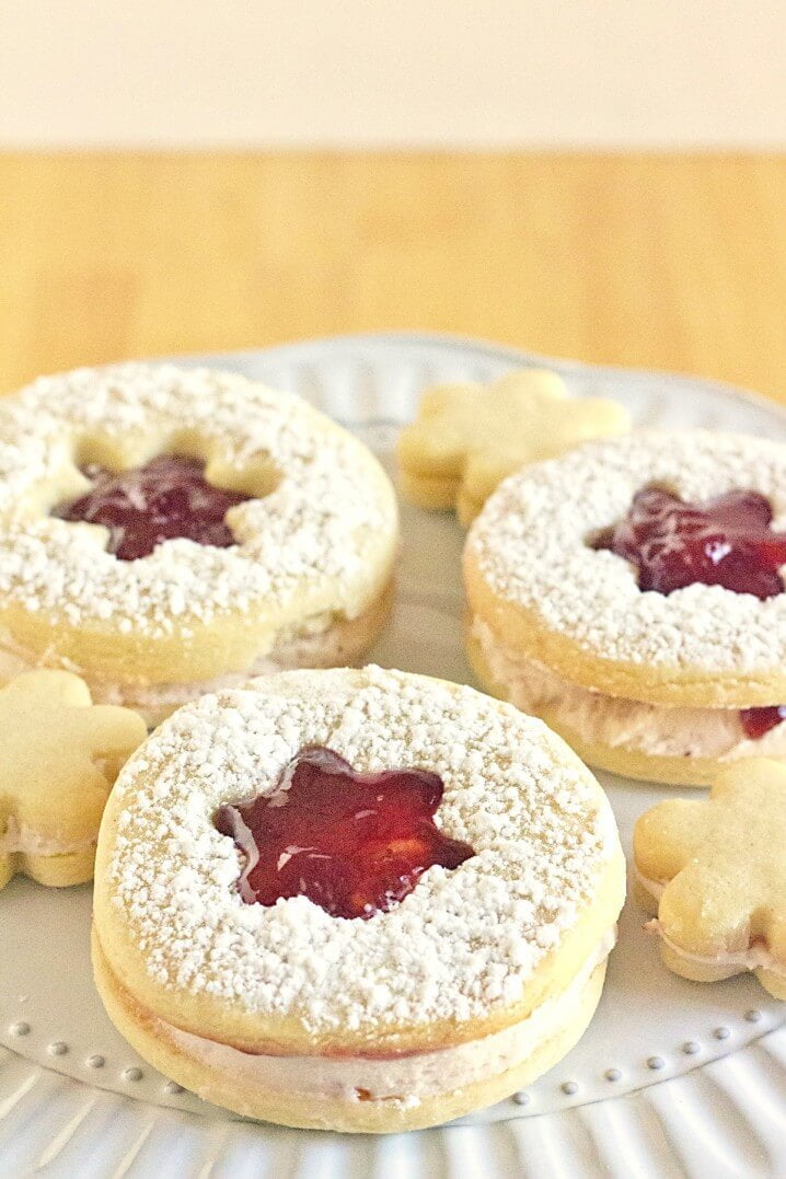 Strawberry Lemon Linzer Cookies Recipe - Sweet, fluffy strawberry filling is sandwiched between soft lemon cookies. Get the recipe on ItsYummi.com