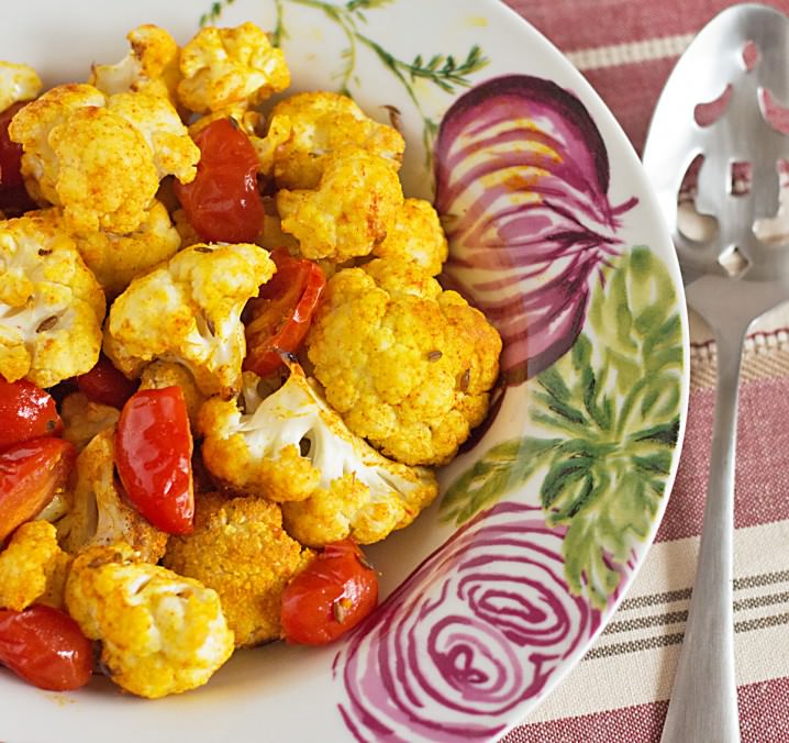 Indian Spiced Roasted Vegetables recipe - cauliflower, grape tomatoes and white cannellini beans are seasoned with tumeric, sweet paprika, and cumin. A great vegetarian dish for meatless Monday or as a side with chicken or lamb!