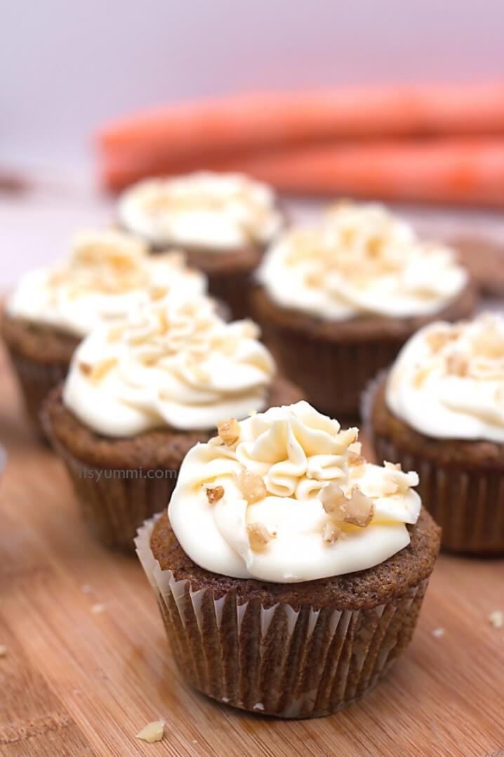 Give this carrot cake cupcake recipe a try and you'll get a bite full of yummi decadence! A carrot cake cupcake is topped with a maple walnut cream cheese frosting. SO yummi!