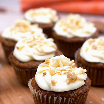 frosted carrot cake cupcakes garnished with walnuts