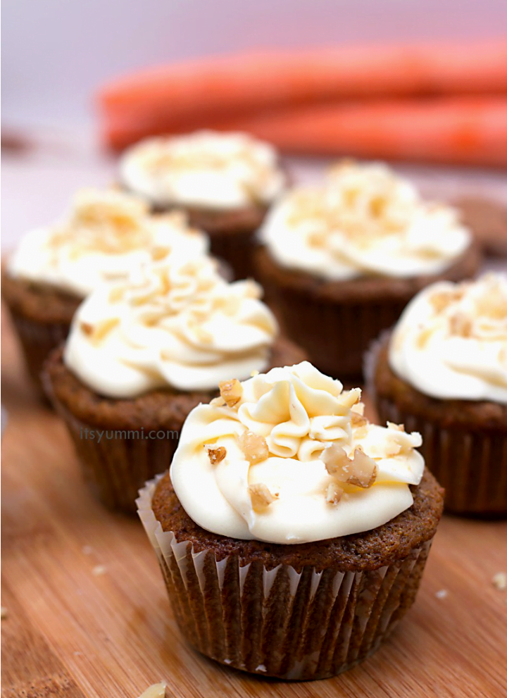 frosted carrot cake cupcakes garnished with walnuts