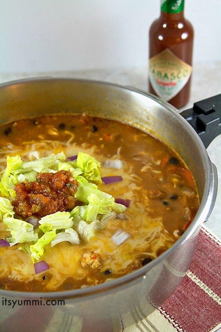 making a chicken enchilada soup recipe on the stove top