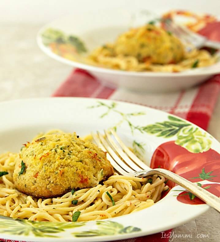 Fresh lump crab meat crab cakes served over a white wine and garlic butter sauce. This crab cake scampi recipe is perfect for a meatless dinner during Lent.