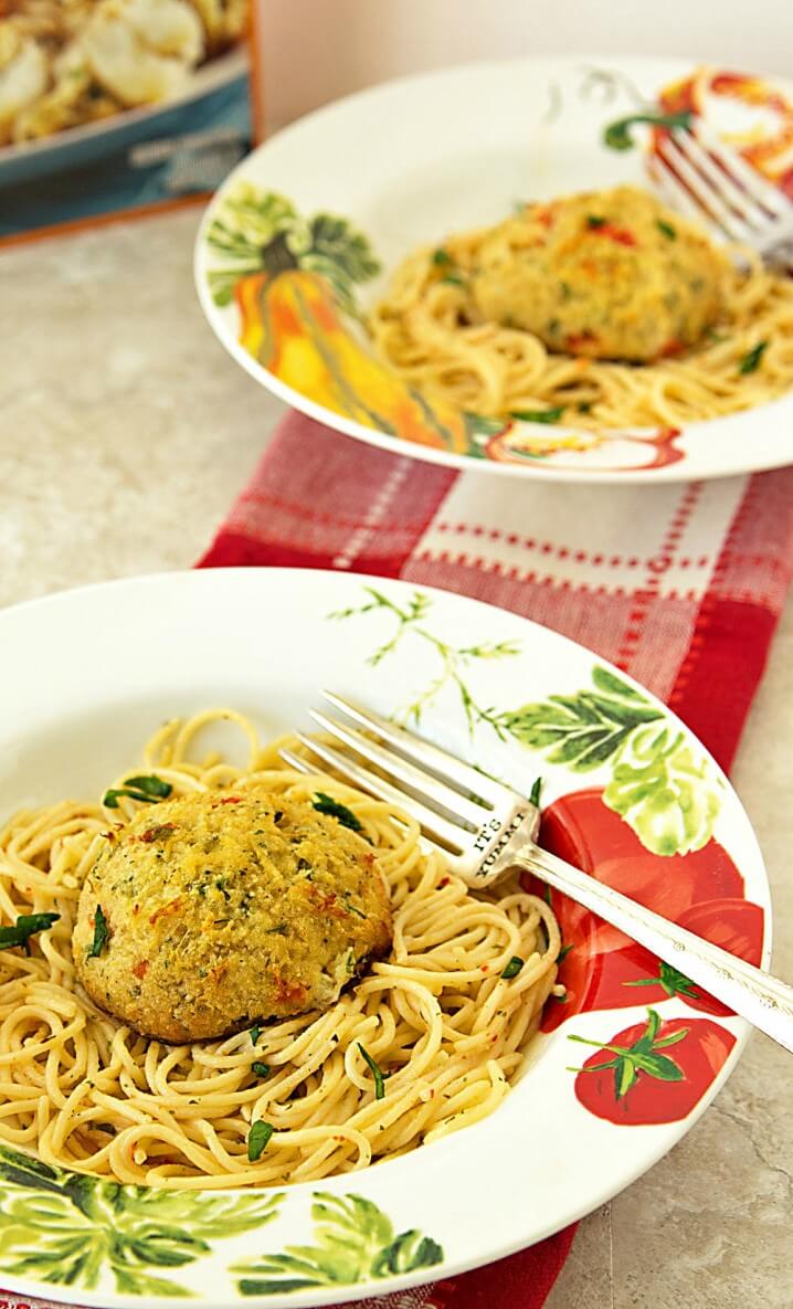 Fresh lump crab meat crab cakes served over a white wine and garlic butter sauce. This crab cake scampi recipe is perfect for a meatless dinner during Lent.