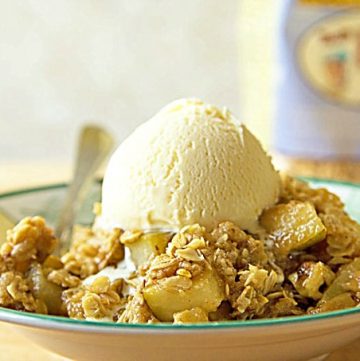 gluten free pear crumble with walnuts and a scoop of vanilla ice cream