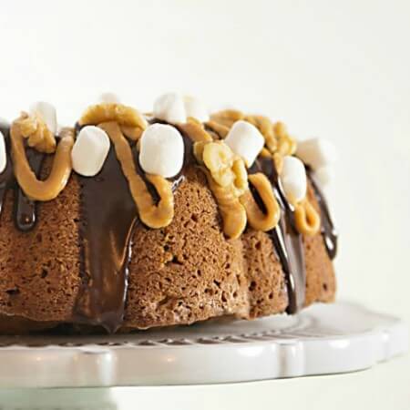 This Elvis on a Rocky Road bundt cake recipe will blow your mind! Peanut butter and bananas are combined with traditional rocky road flavors to create this delicious cake!