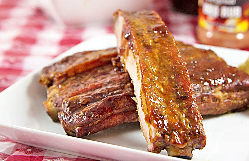 Cajun-Spiced Smoked Spare Ribs Recipe from ItsYummi.com - This recipe has an option for smoking the ribs with a smoker or baking them in an oven. They're dry rubbed first and then finished off with a tangy Louisiana style barbecue sauce.