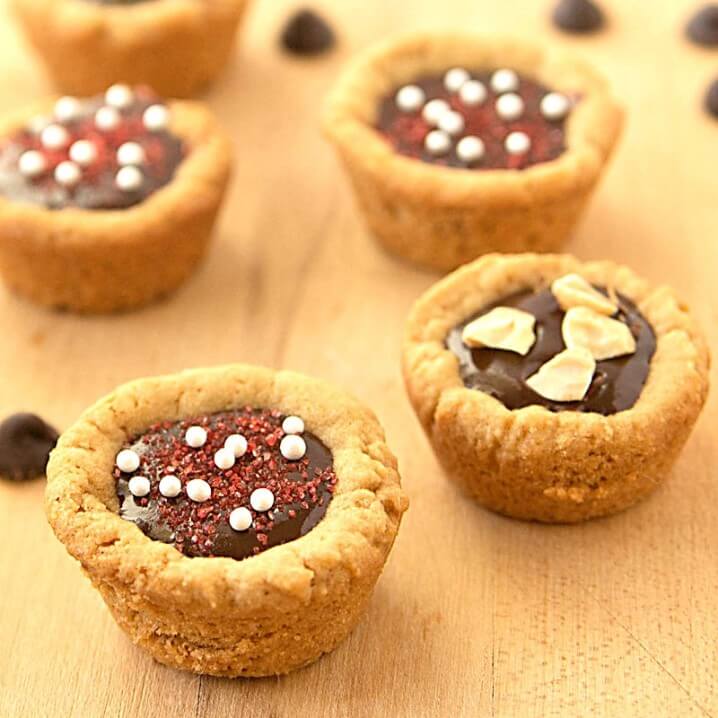 Chocolate Ganache Filled Peanut Butter Cookie Cups - The perfect bite-sized cookie for a snack or to place on a holiday cookie platter. Get the recipe from @itsyummi