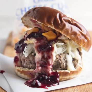 Wisconsin Grass Fed Bison Bratwurst Burger - made with fresh ingredients from Wisconsin! Door County cherry jam, homemade beer cheese sauce, and fresh, squeaky cheese curds. Open wide! Recipe from @itsyummi