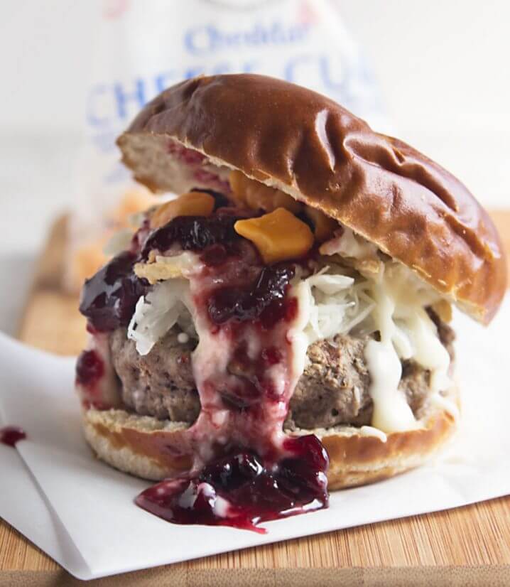 Wisconsin Grass Fed Bison Bratwurst Burger - made with fresh ingredients from Wisconsin! Door County cherry jam, homemade beer cheese sauce, and fresh, squeaky cheese curds. Open wide! Recipe from @itsyummi