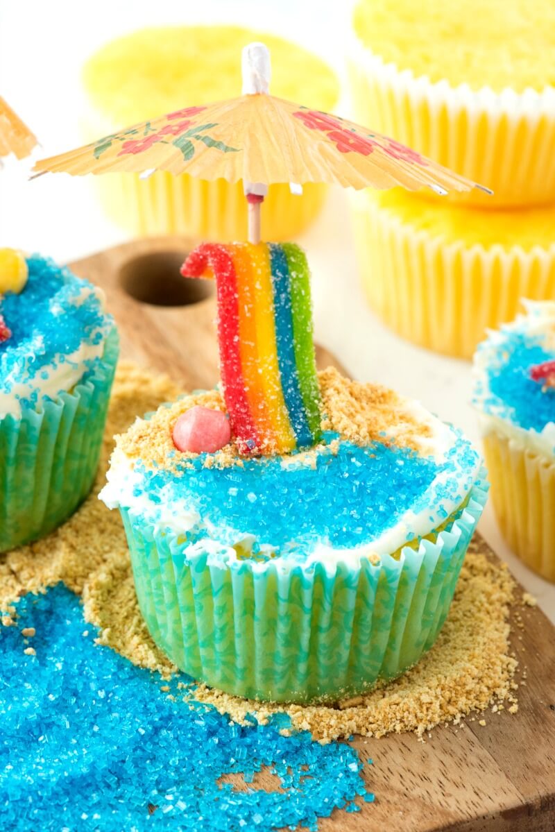 homemade cupcakes decorated with candy in a beach theme