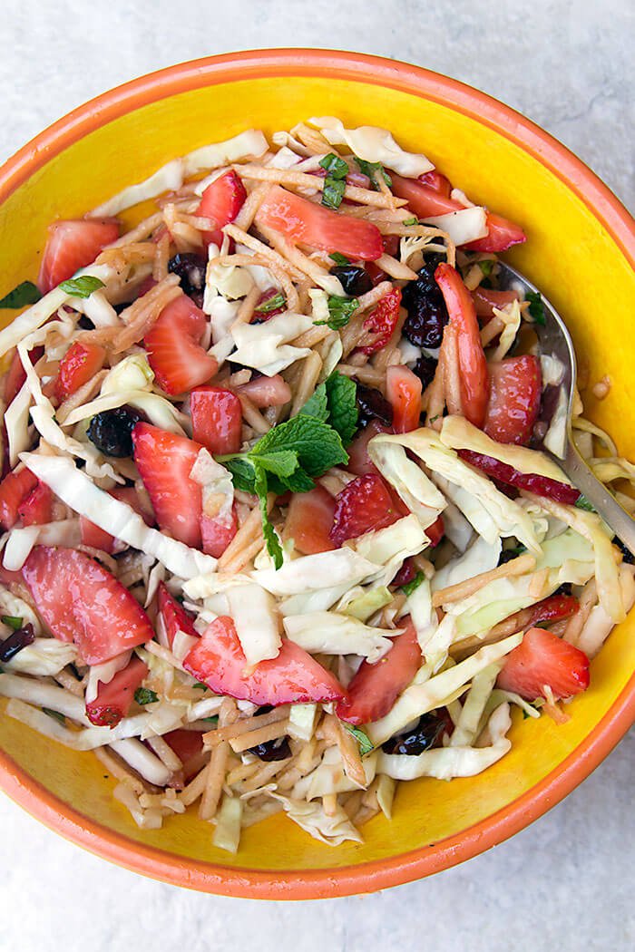 Tossed Strawberry-Apple Coleslaw, with a healthier coleslaw dressing, made without mayo.
