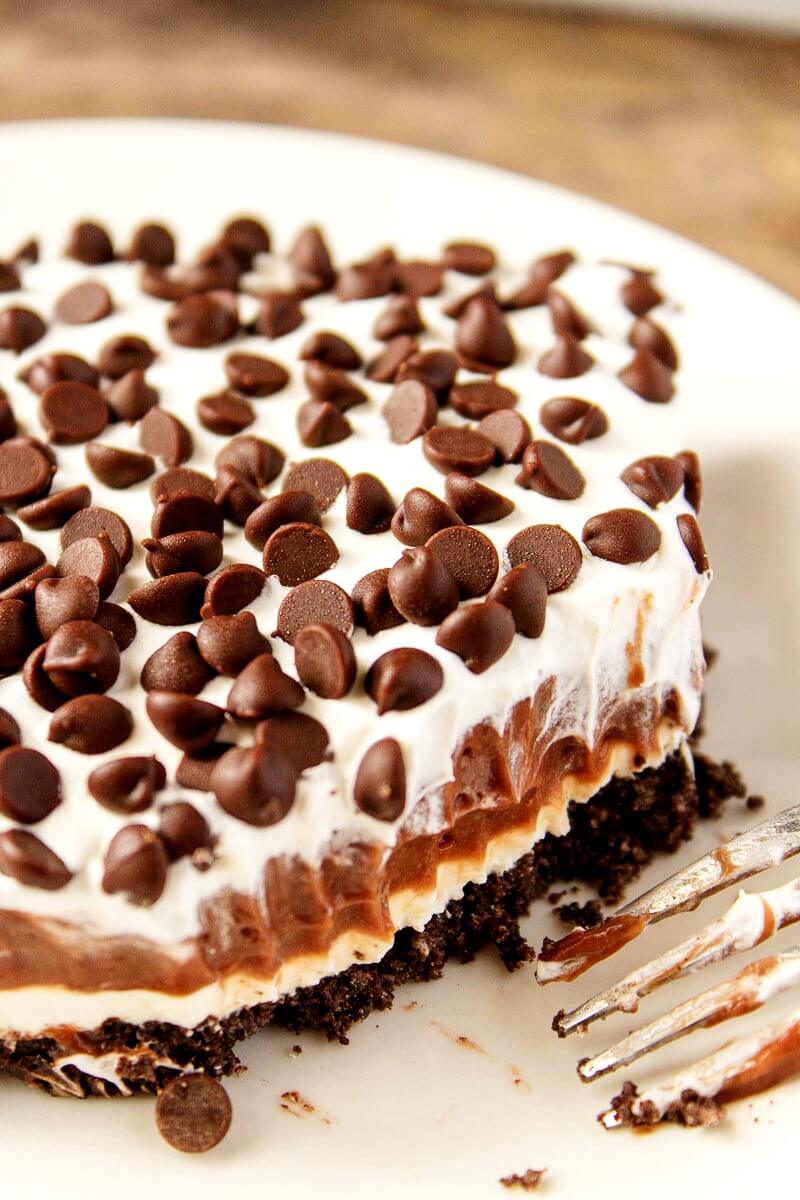 Chocolate Dessert Lasagna (also called Chocolate Lush or Chocolate Icebox Cake) Chocolate lasagna is a layered dessert with layers of chocolate cookies, chocolate pudding, whipped cream and chocolate chips! #nobake #dessert #recipe #chocolate