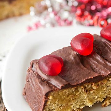 slice of low carb chocolate almond flour cake decorated for Valentine's Day