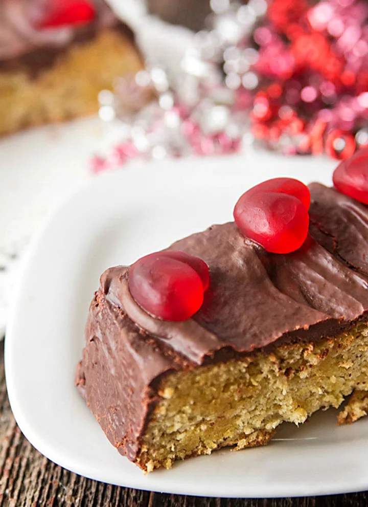 slice of low carb chocolate almond flour cake decorated for Valentine's Day