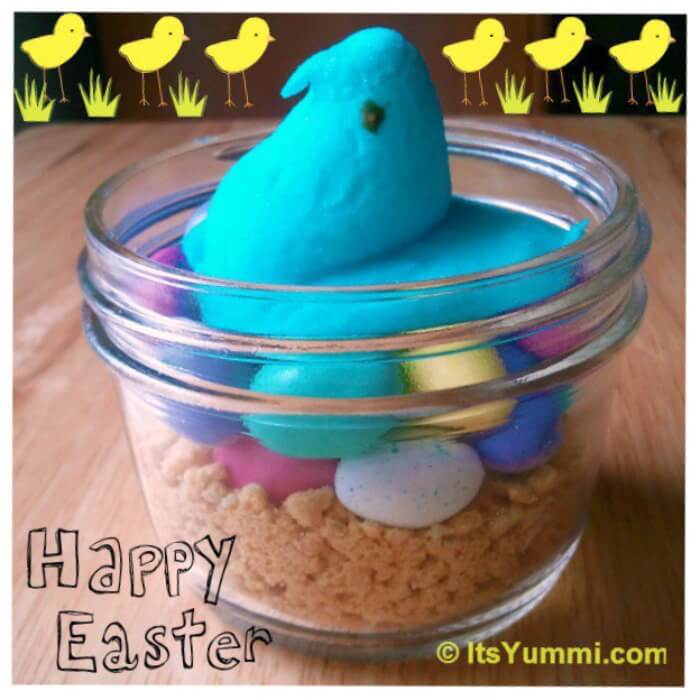 marshmallow peep mama to be sitting on a "nest" of malted milk ball eggs in a mason jar