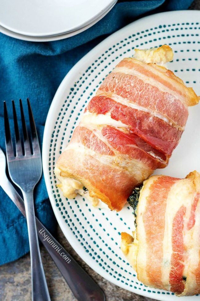 overhead image of low carb chicken breast bundles stuffed with spinach and cheese, wrapped in bacon