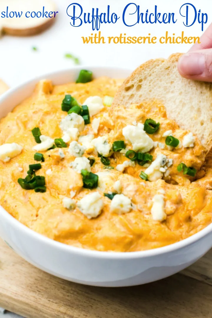 This Crockpot Buffalo Chicken Dip recipe makes a warm, spicy cheese dip using rotisserie chicken. One of the best game day appetizers for a football party, this easy dip recipe is a low carb dip, too! #buffalochickendip #rotisseriechicken #gamedayappetizers dipping crostini into bowl of buffalo chicken dip